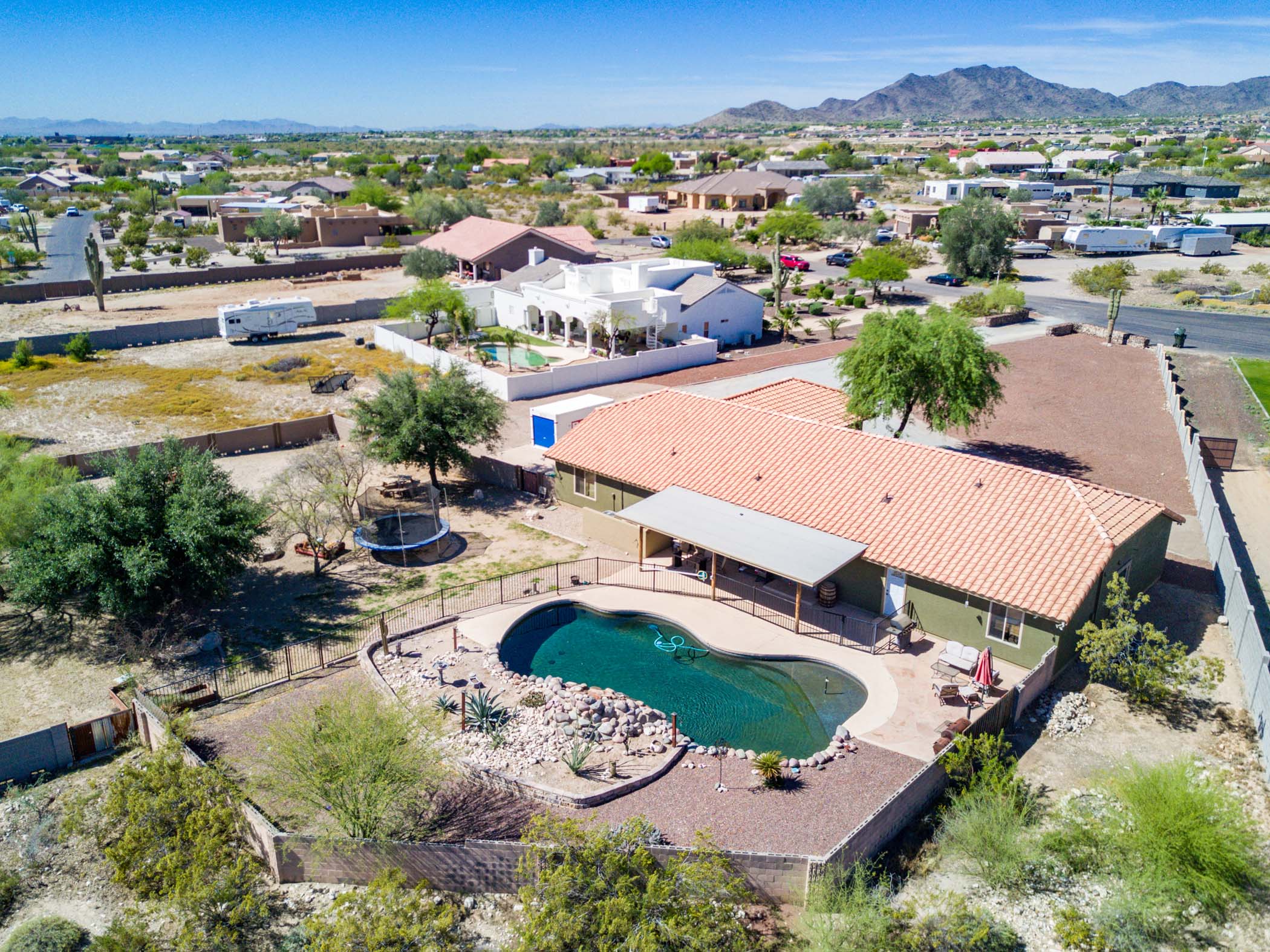 Aerial view of desert home with backyard pool