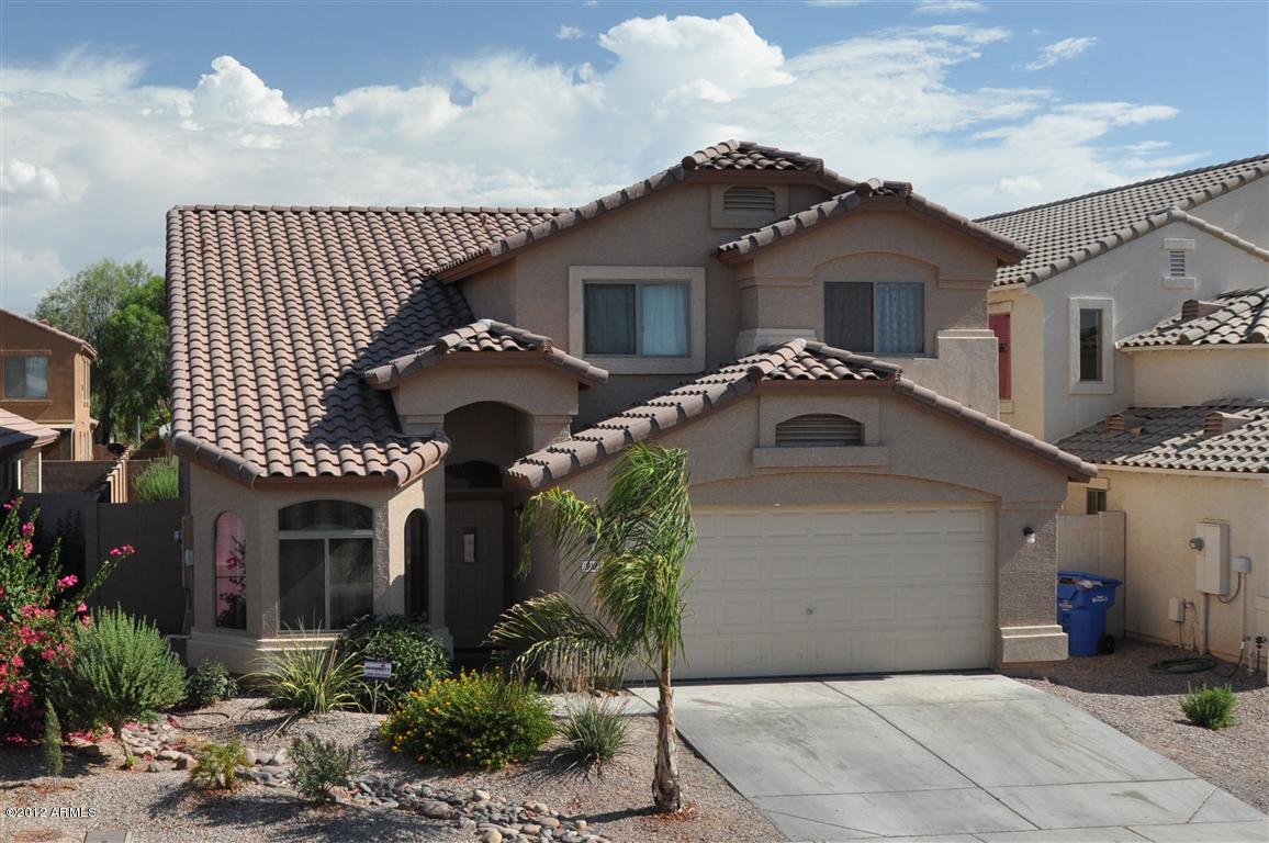 Two story stucco house with tile roof